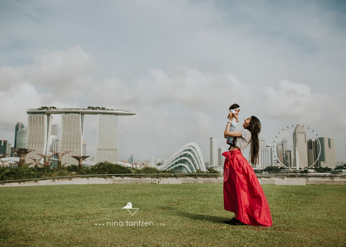 beautiful image of mother and baby in front of singapore skyline