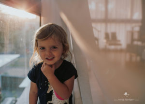 professional photo of girl next to window in singapore