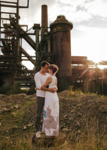 couple holding each other in front of sunset