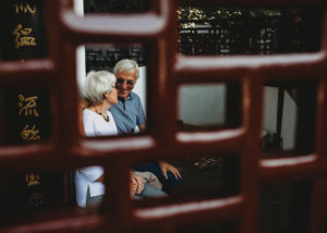 older couple photographed through Chinese door