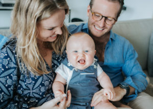 parents with laughing baby boy