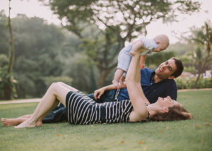 parents with baby on the lawn