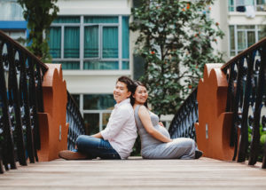 couple sitting on bridge