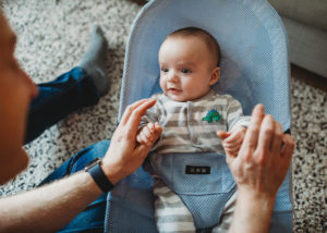baby gazing up at dad