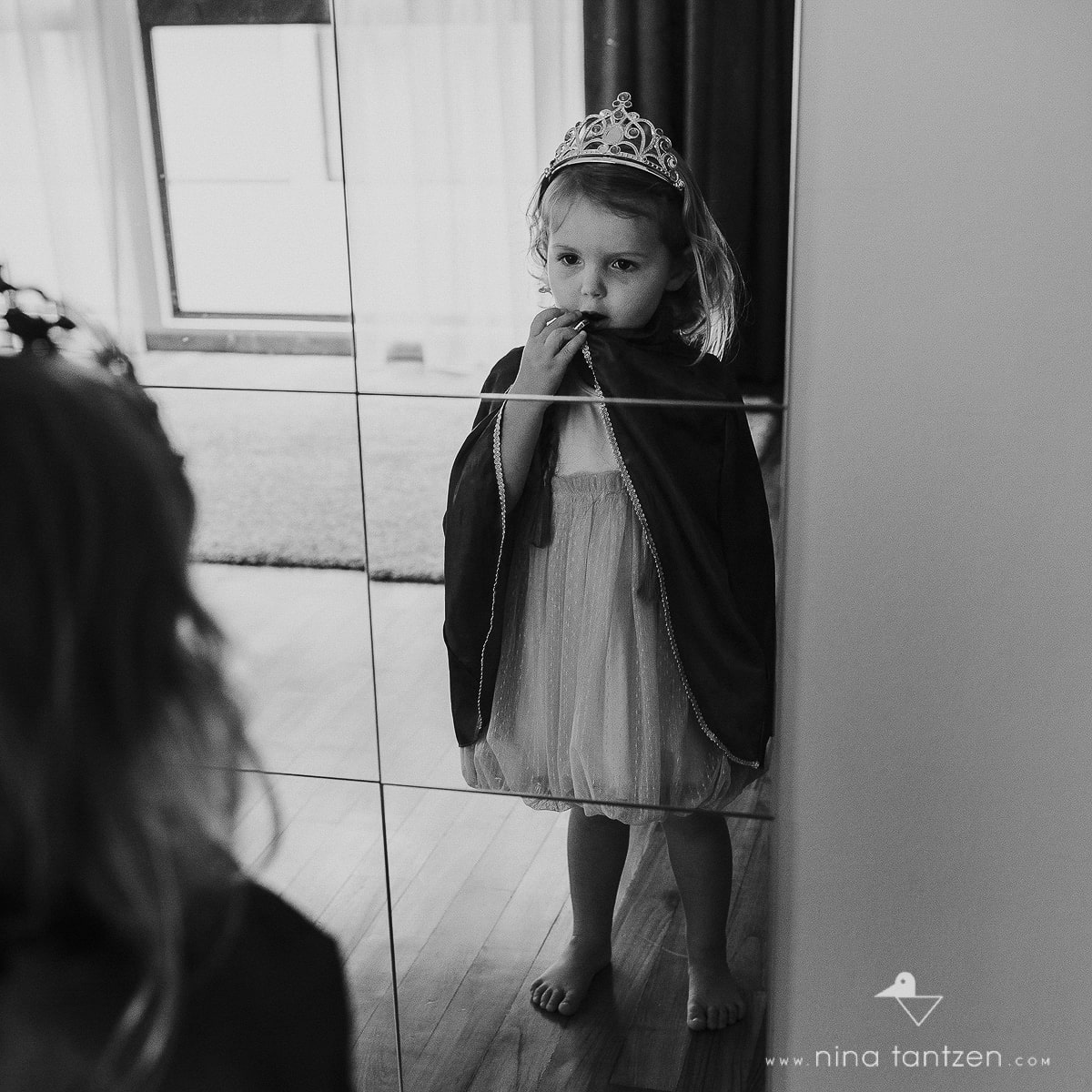 little girl looking into mirror