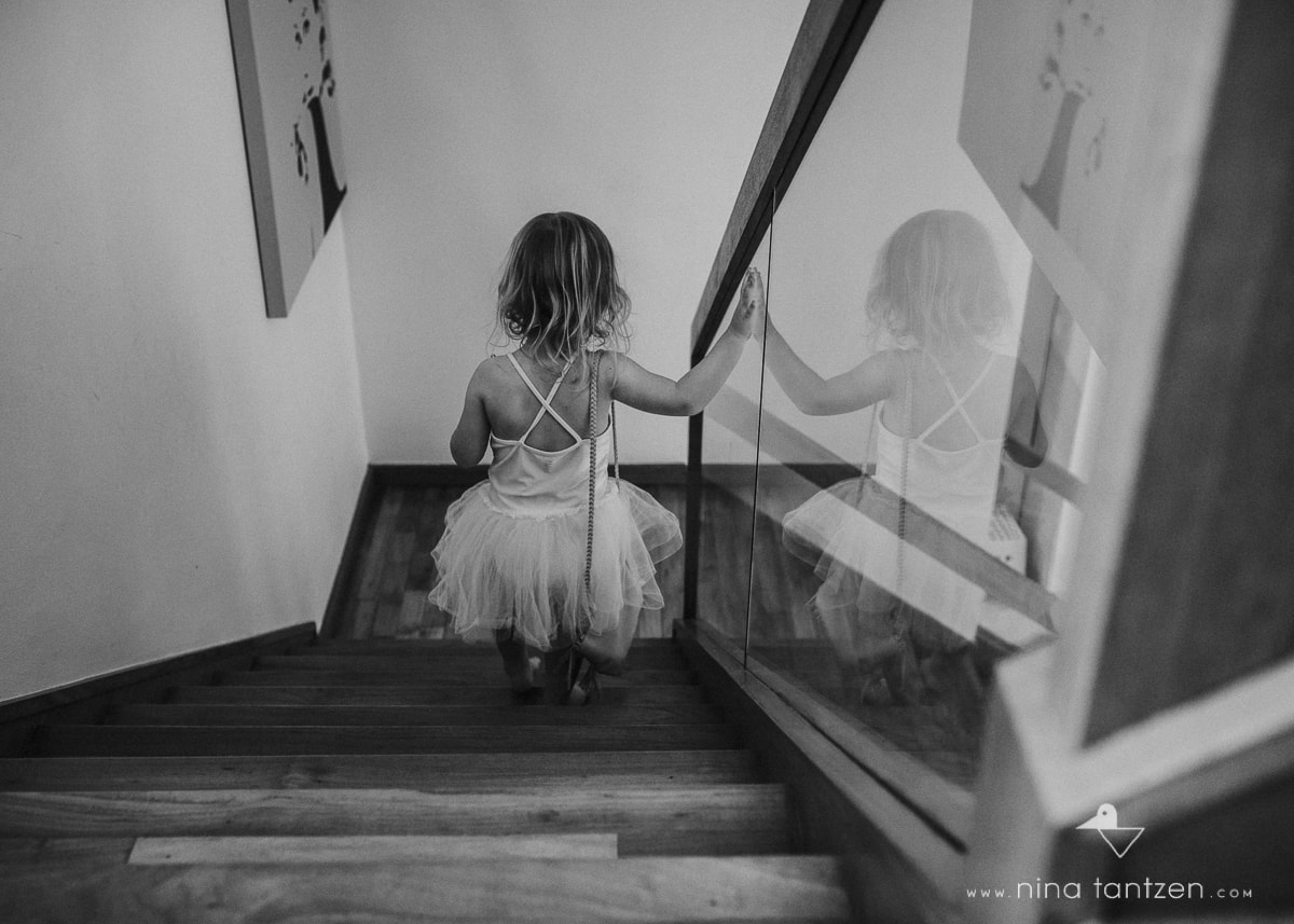girl walking down stairs in a tutu