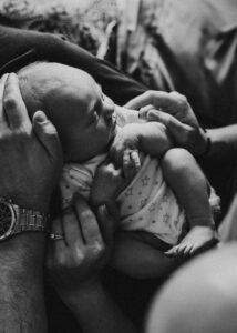 newborn baby in his parents lap