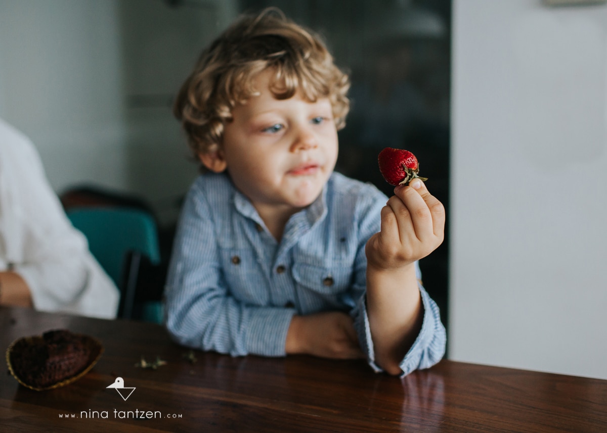 photo of child holding strawberry