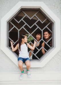 portrait of a couple and their daughter in a Chinese garden
