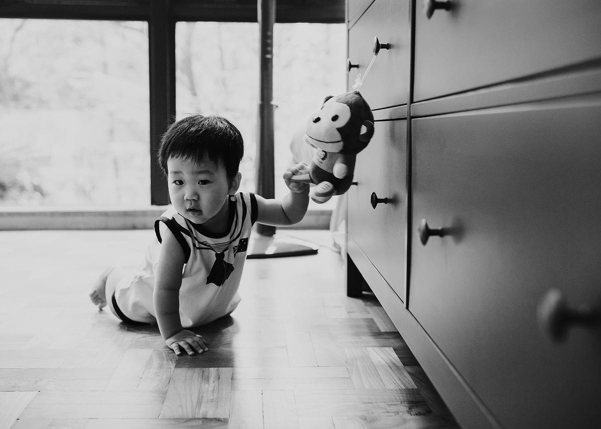 photo of crawling baby with toy