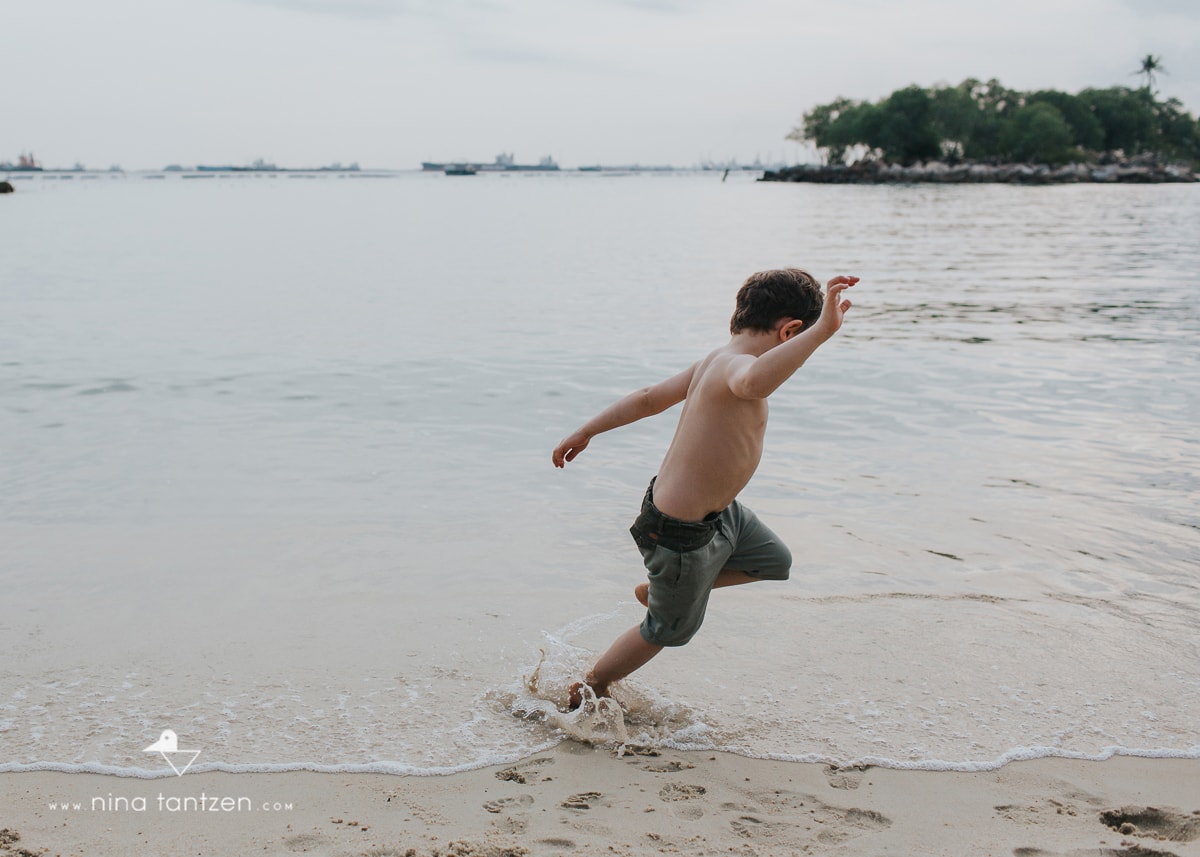 portrait of boy on the beach in singapore