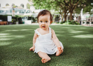 portrait of baby sitting in grass