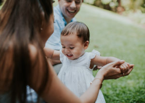 baby taking ehr first steps with parents