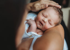 mom holding her newborn baby viewed from above