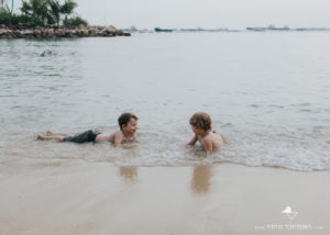 photo of children splashing in the water on sentosa