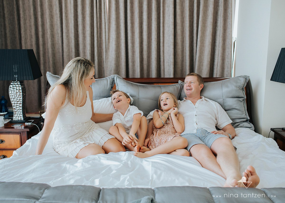 family of four on the bed