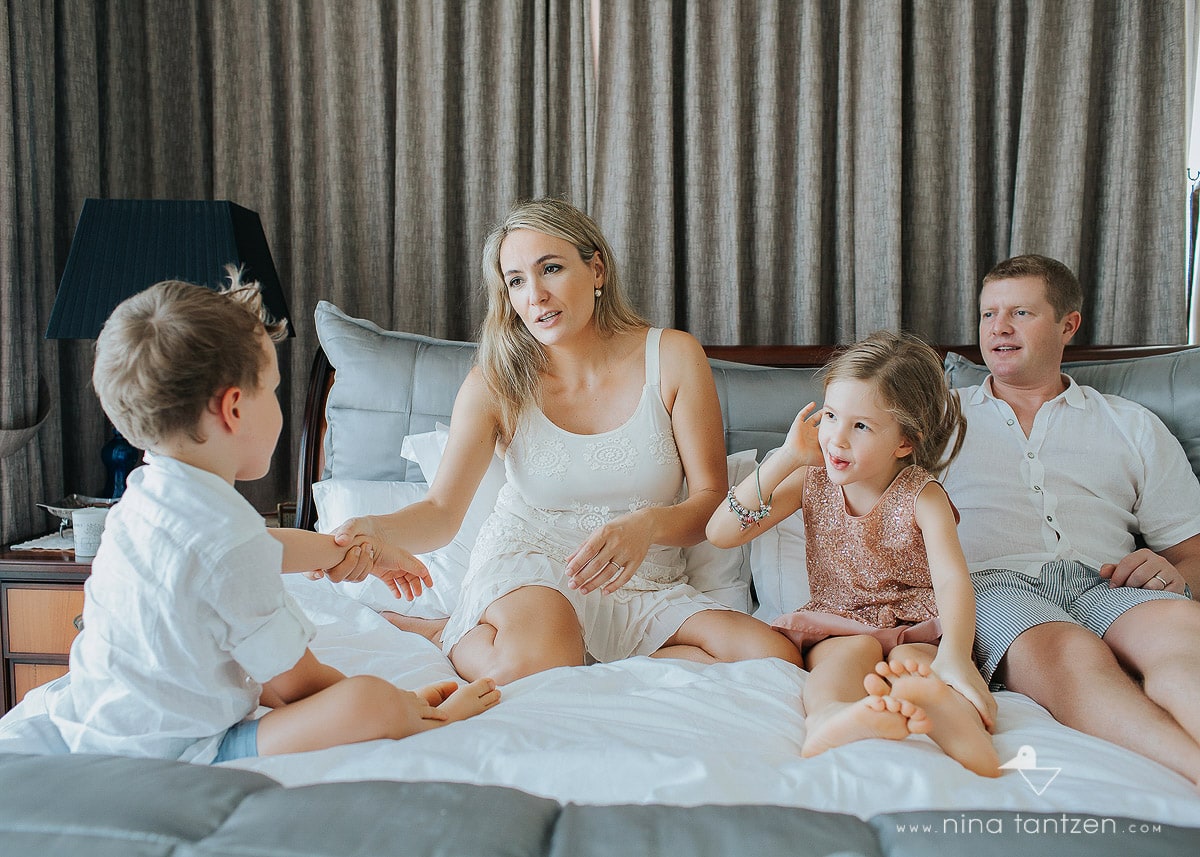 family playing together on the bed