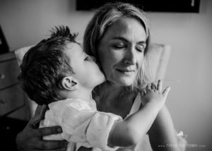 little boy kissing his mother on the cheek