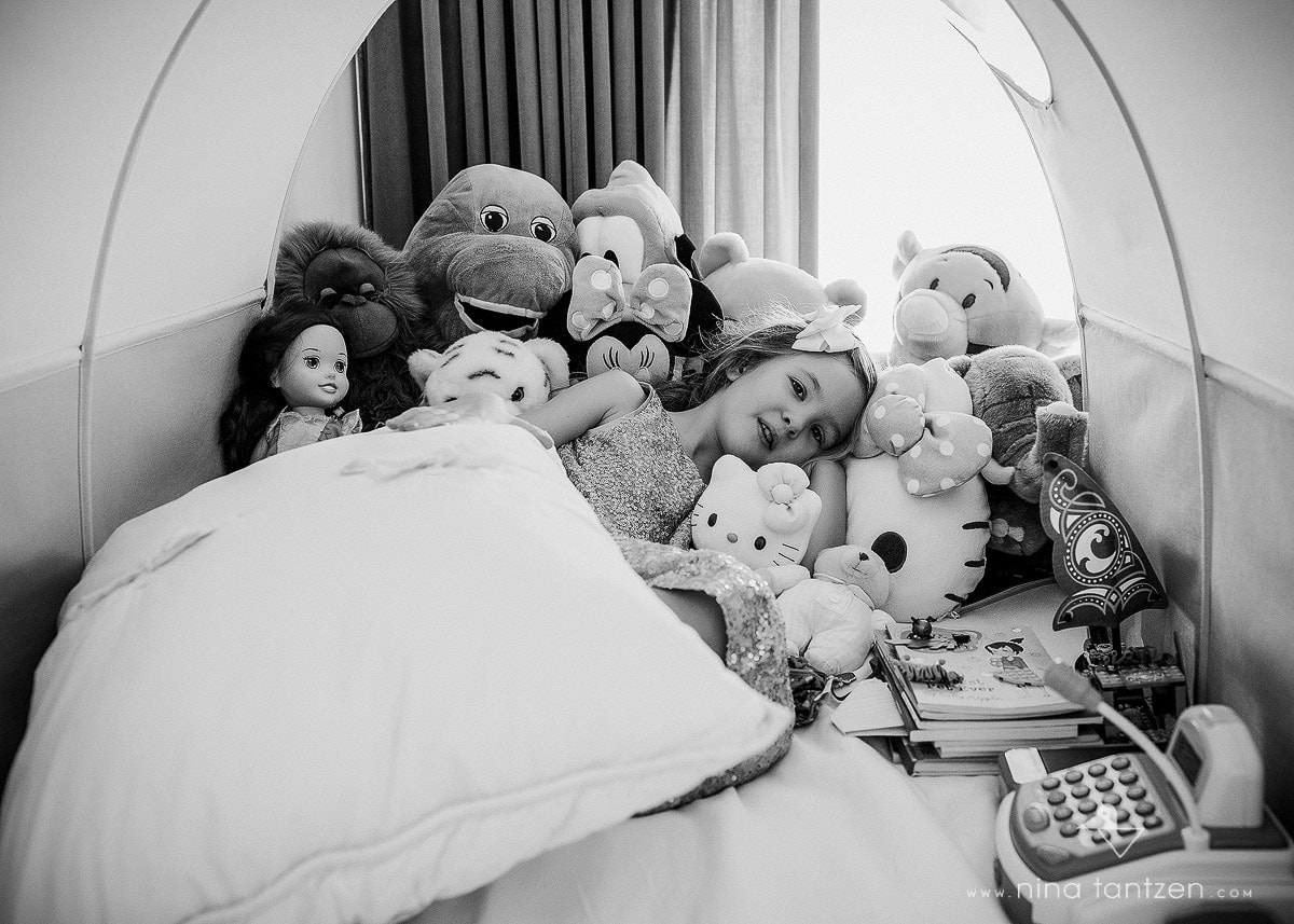 portrait of a girl with her stuffed animals