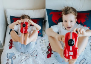 photo of little boy playing with a car