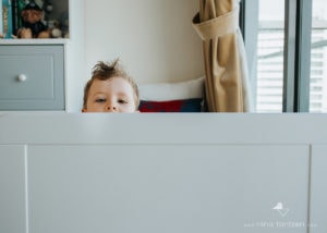 little boy playing peekaboo