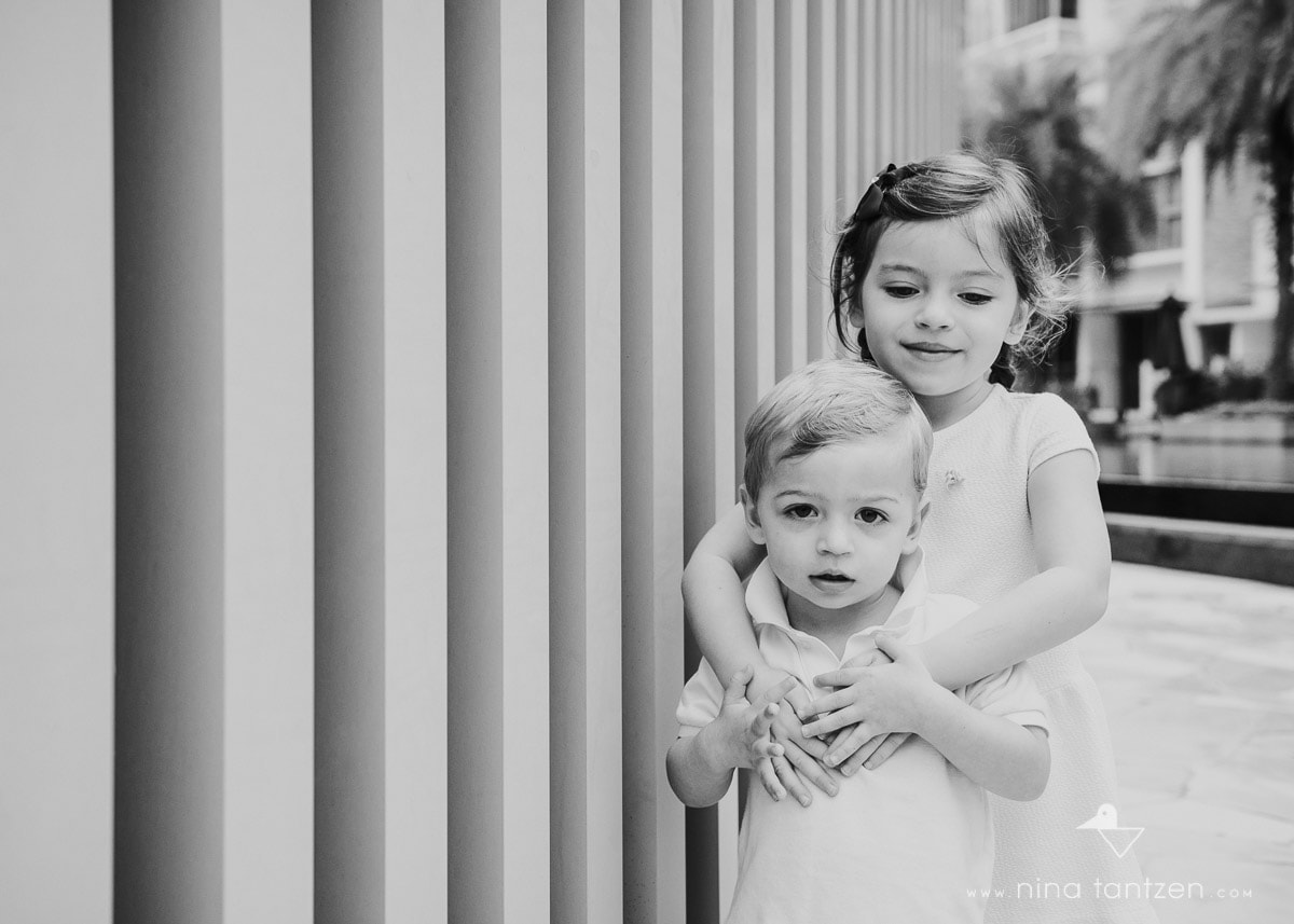 portrait of siblings hugging