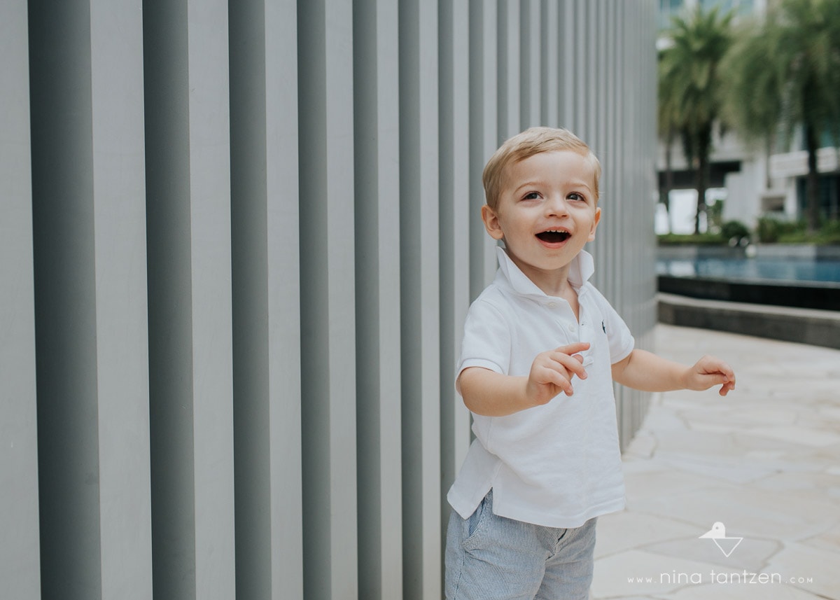 portrait of a giggling 2 year old boy