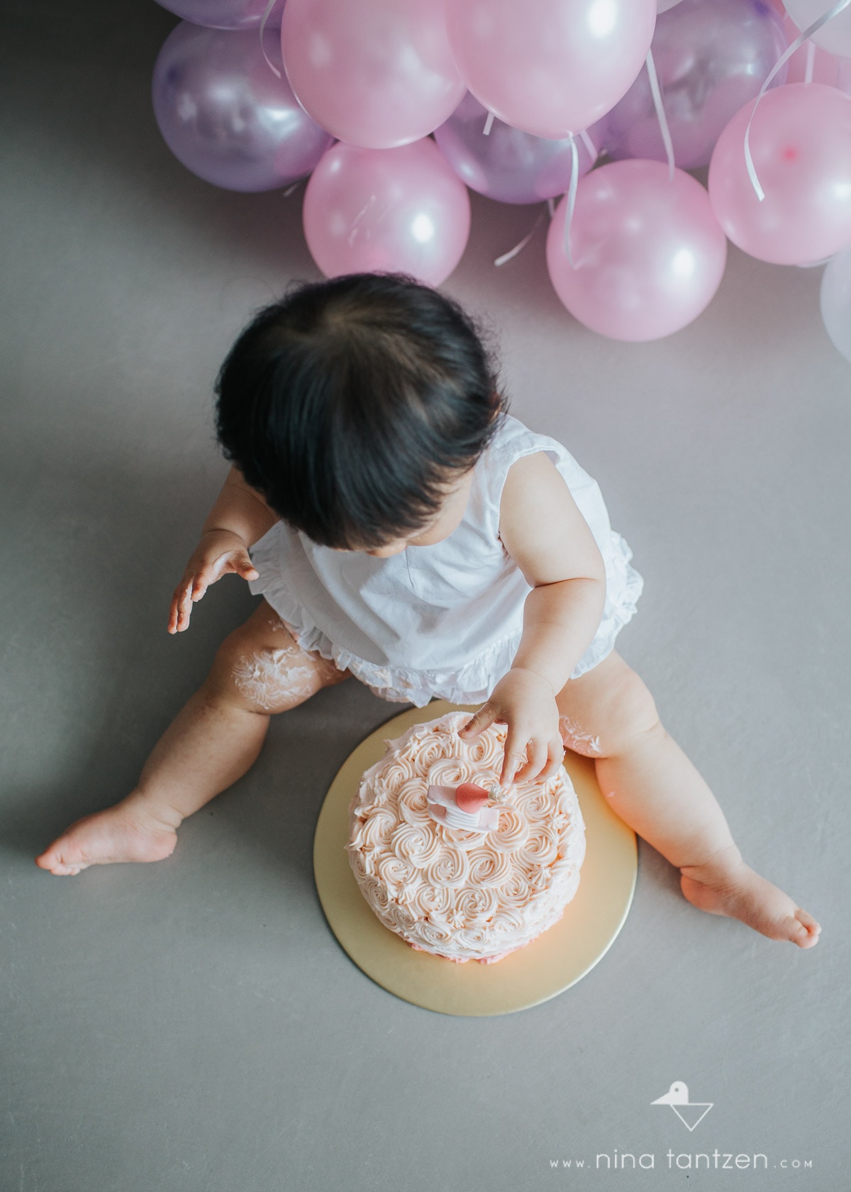 toddler's hand in cake
