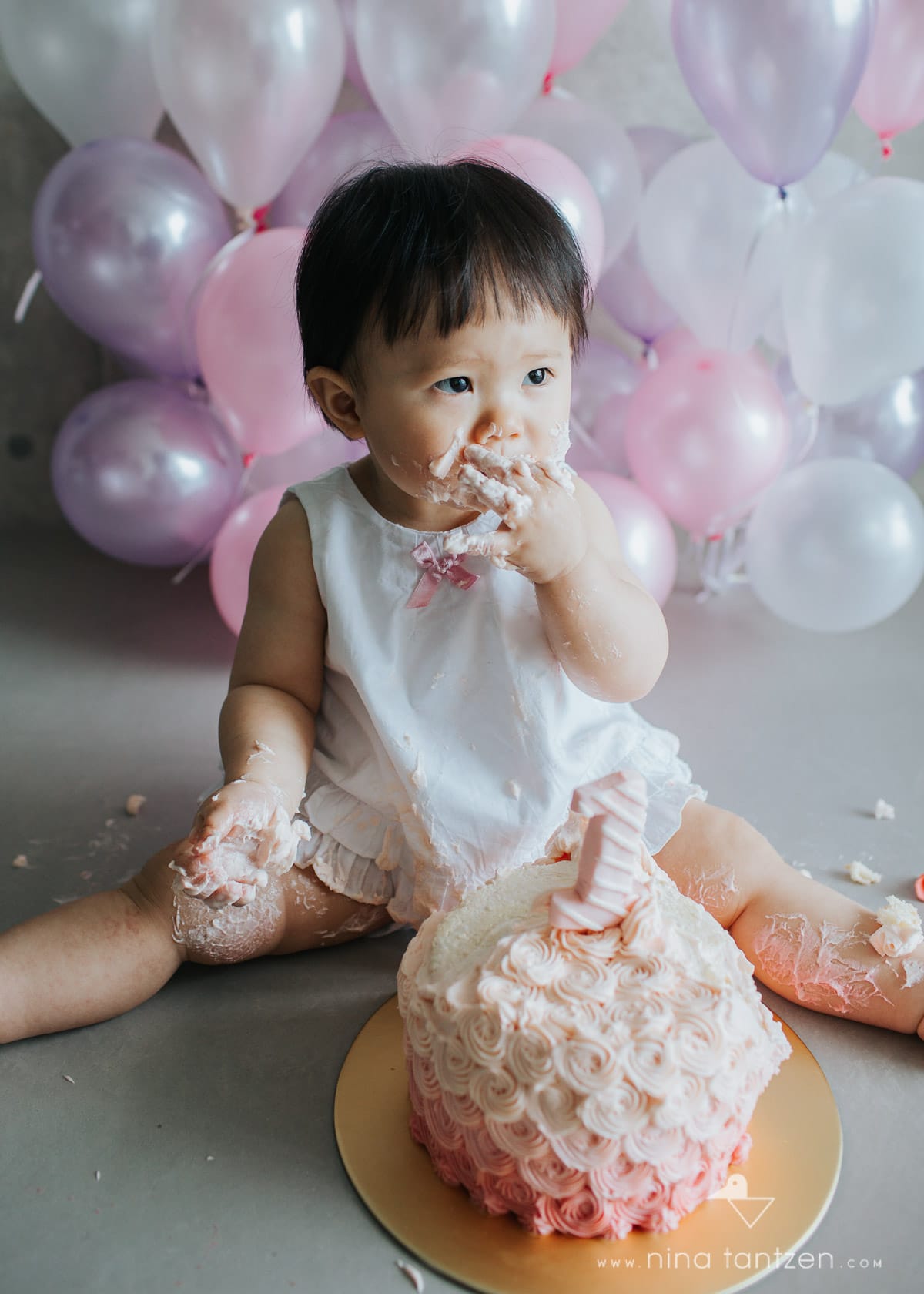 little girl digging into cake