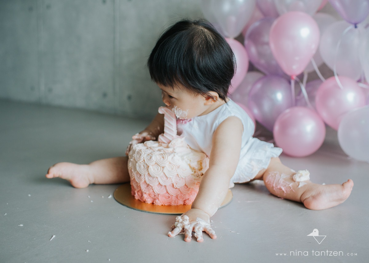 toddler girl with face full of cake