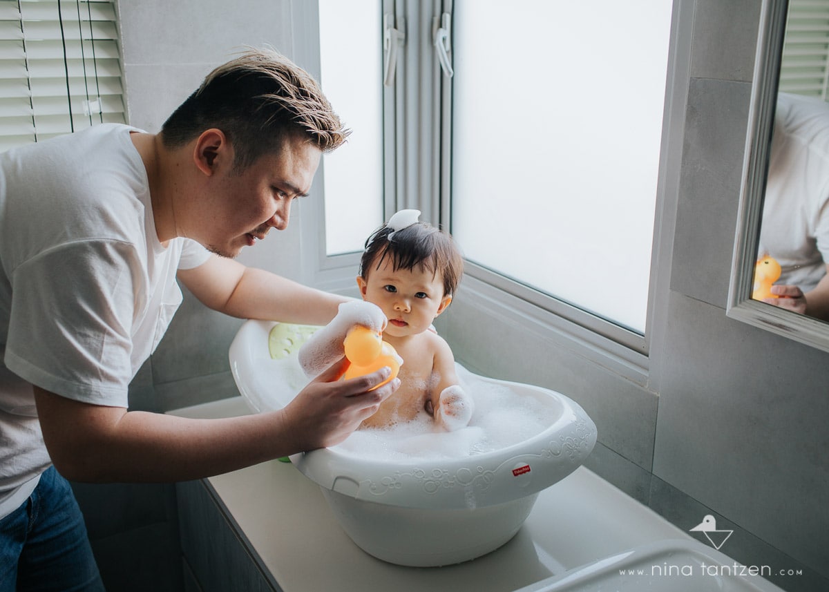 dad giving baby girl a bath