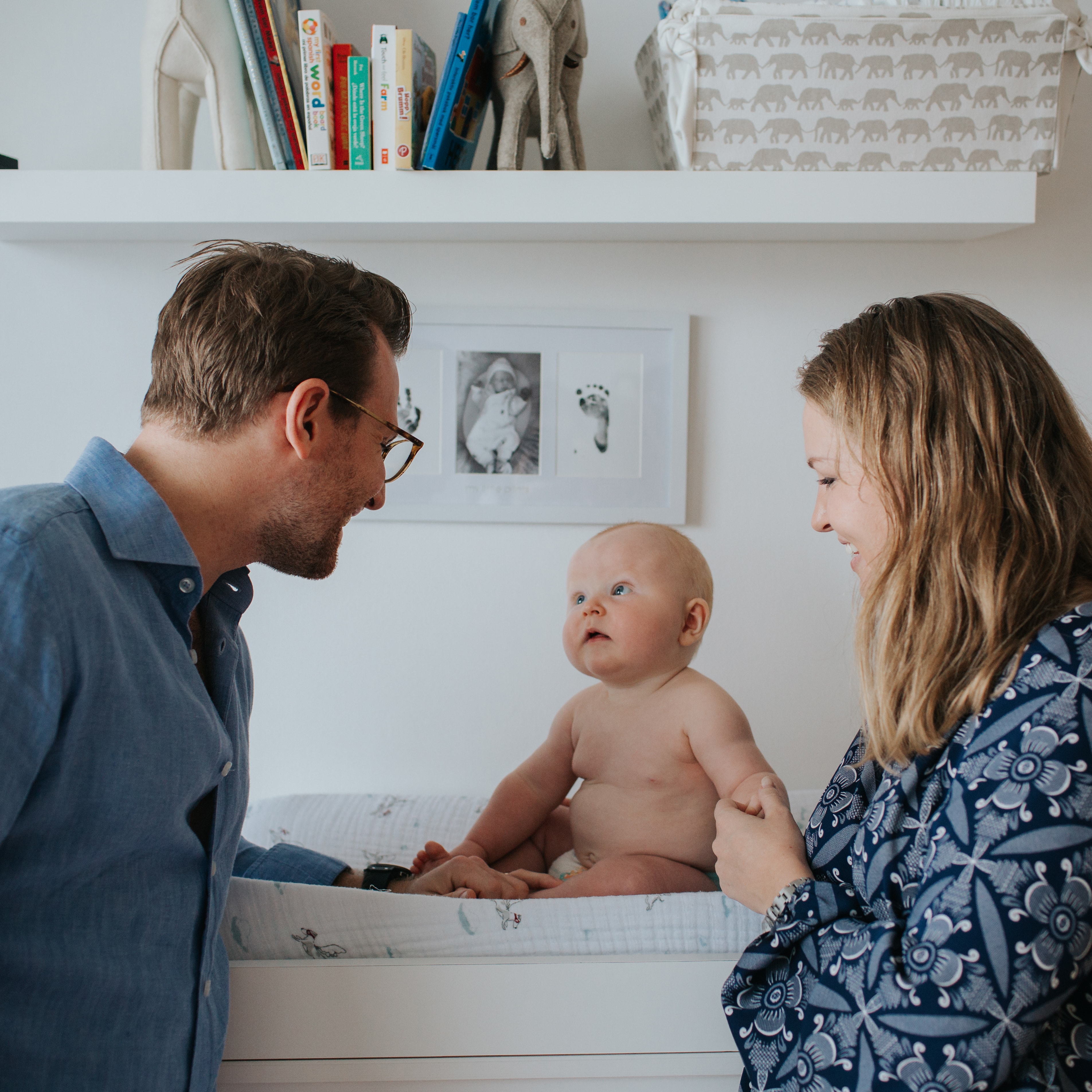 parents with their baby boy on changing table