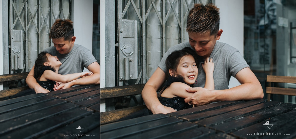 portraits of dad holding his daughter