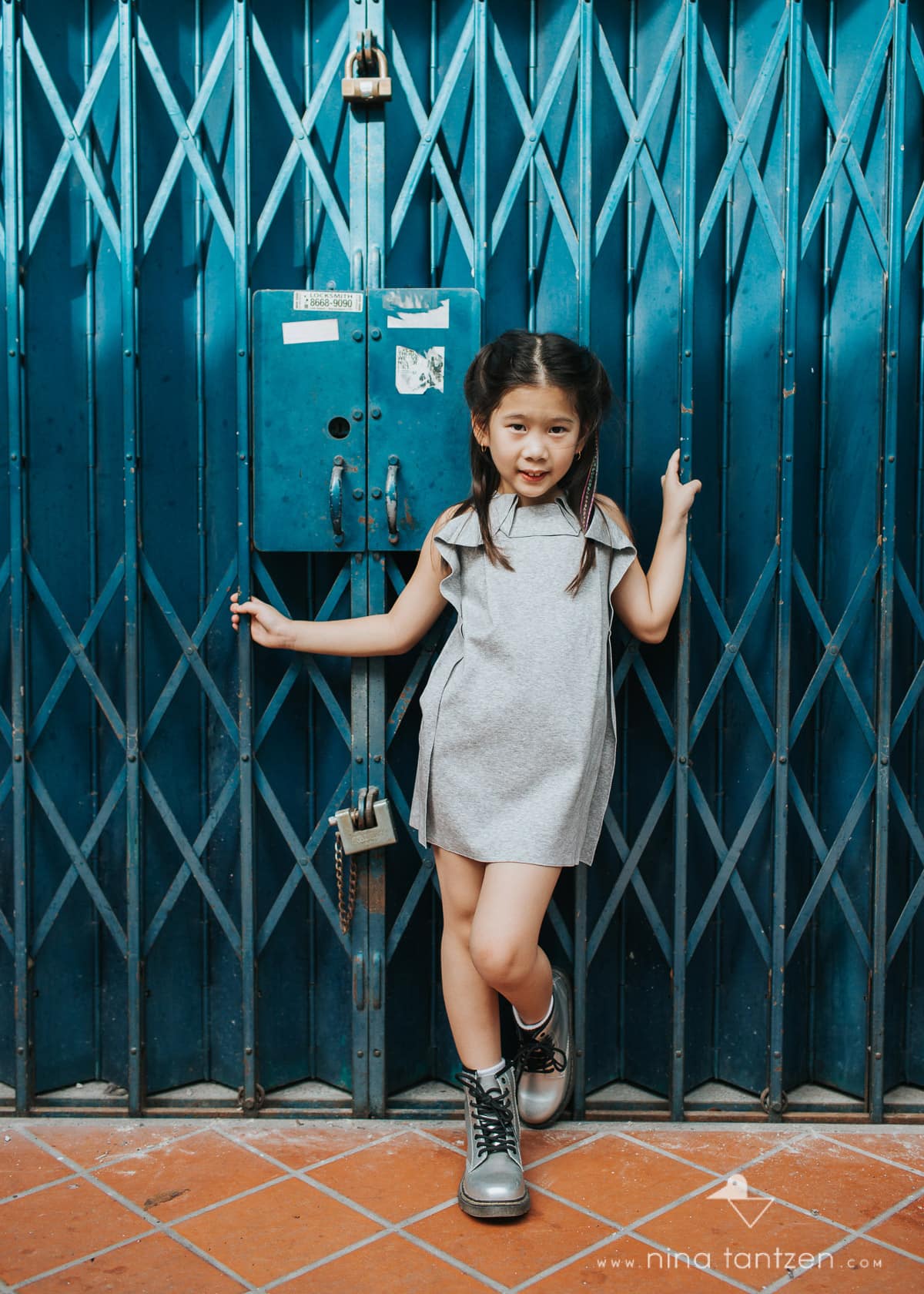 portrait of girl in front of blue doors