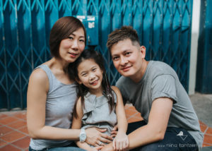 family portrait in front of blue doors