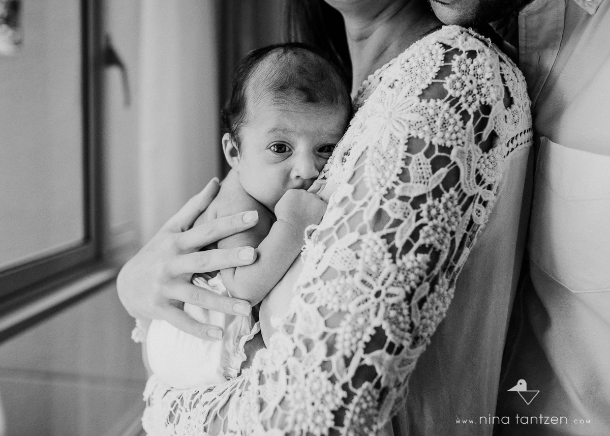 baby being held by parents