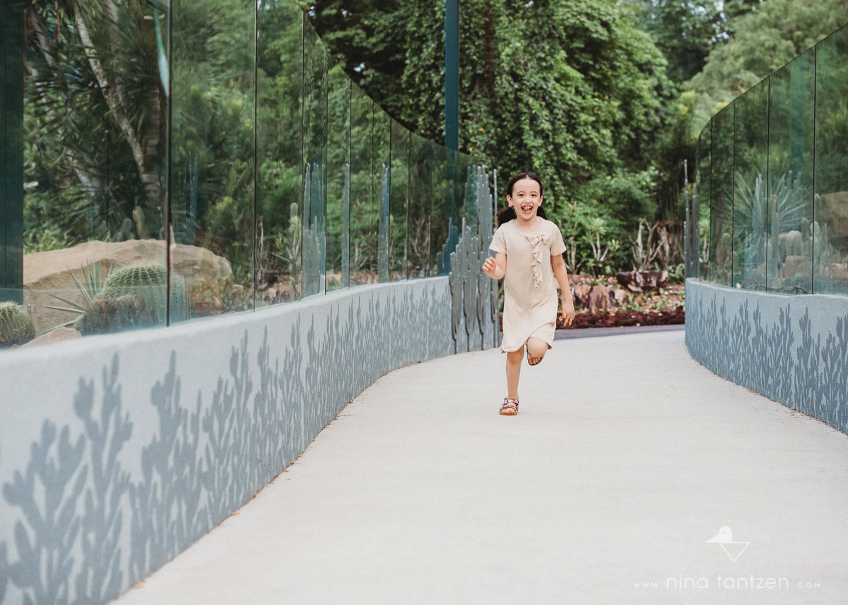 girl running in Singapore's Botanic Gardens