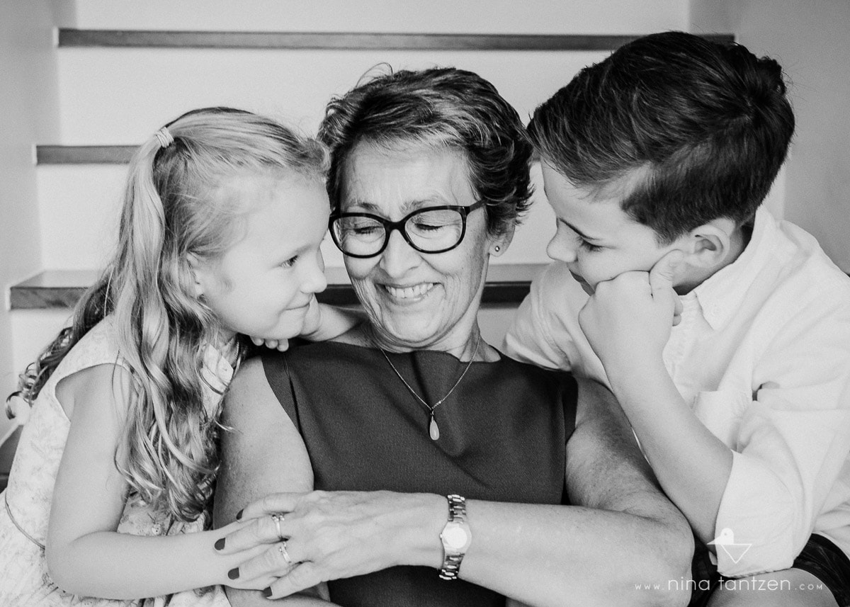 woman and her grandchildren laughing