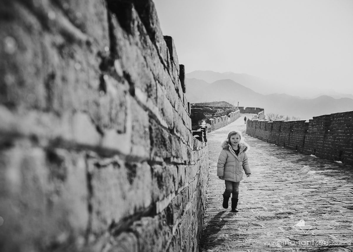 monochrome of little girl on great wall of china