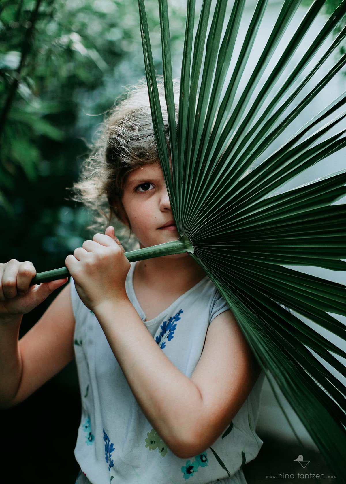 portrait of girl with big leaf