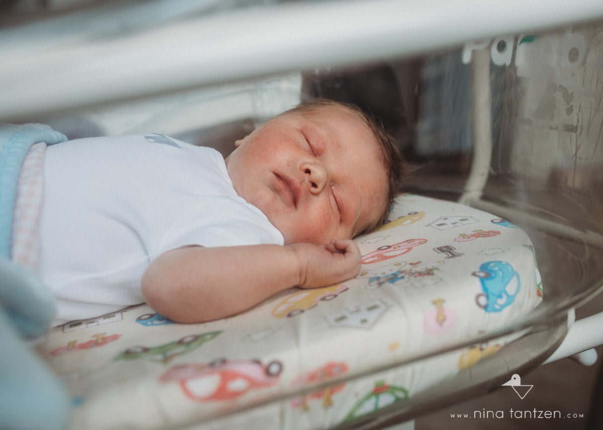 newborn boy in hospital bassinet