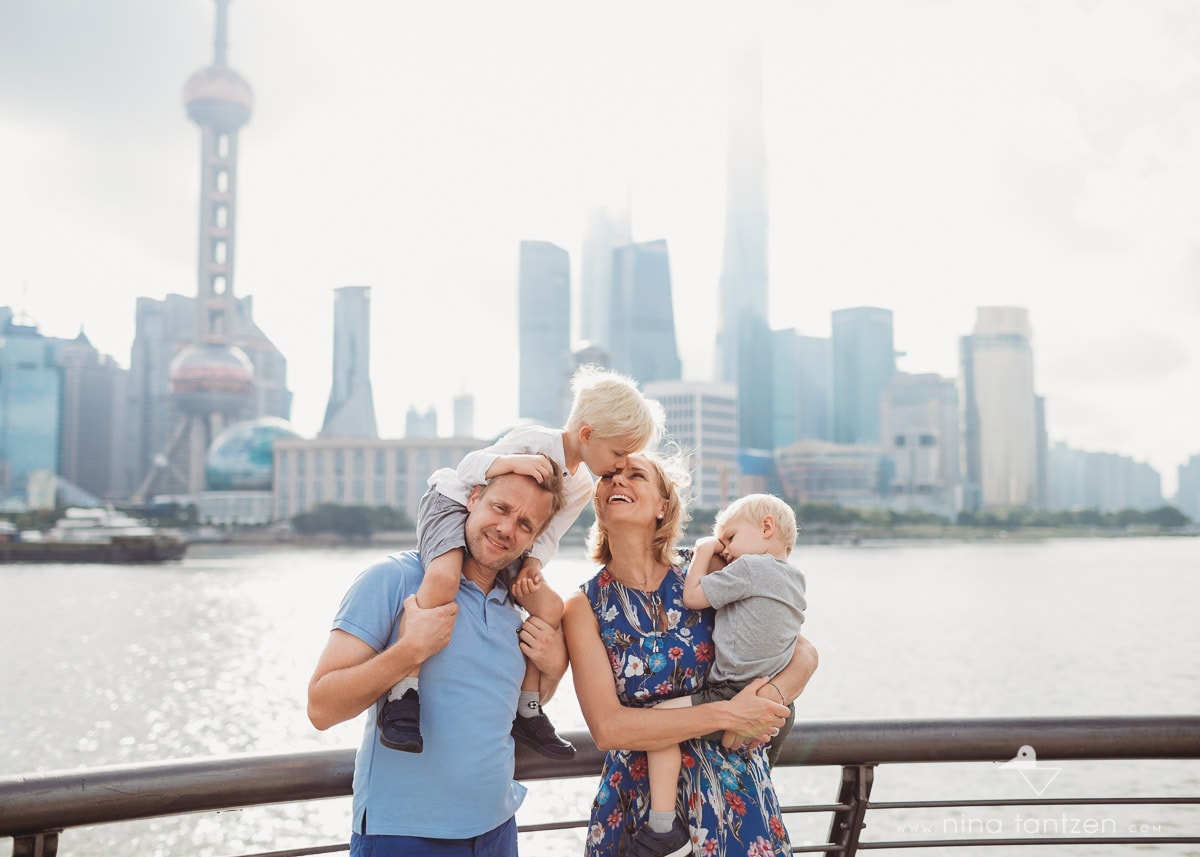 Beautiful family portraits in front of Shanghai skyline