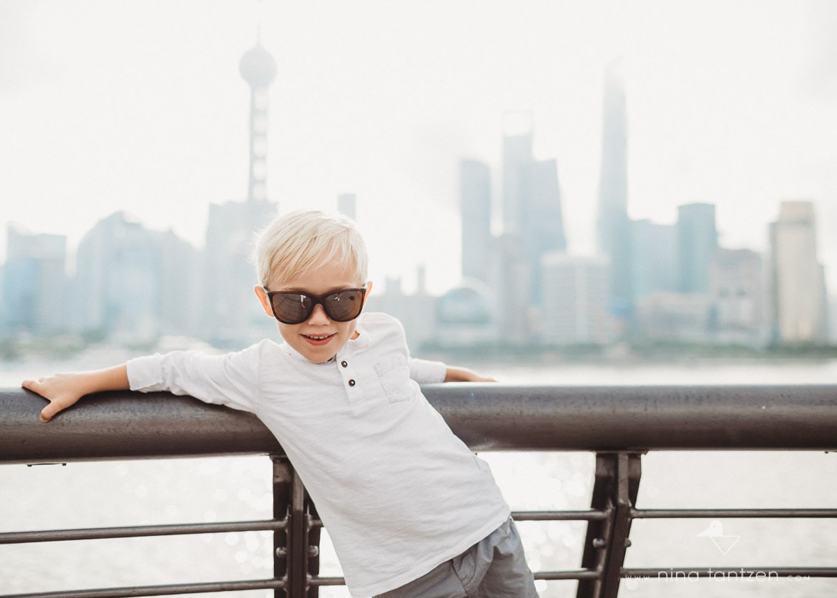 little boy and shanghai skyline