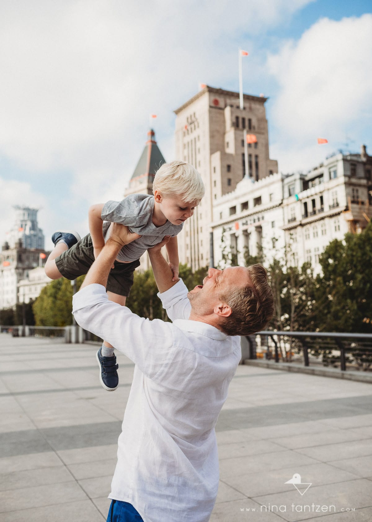 father playing with son on the shanghai bund
