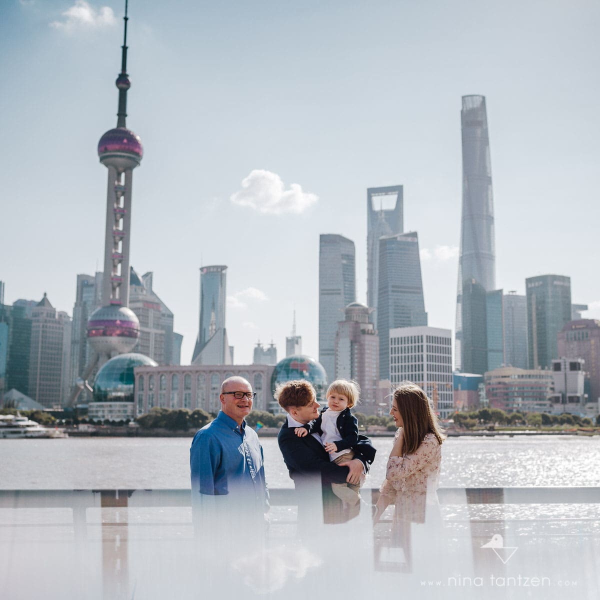 family portrait in front of the Shanghai Skyline