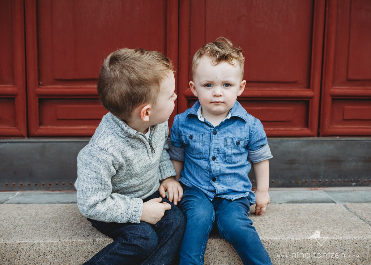 little boy looking lovingly at his little brother