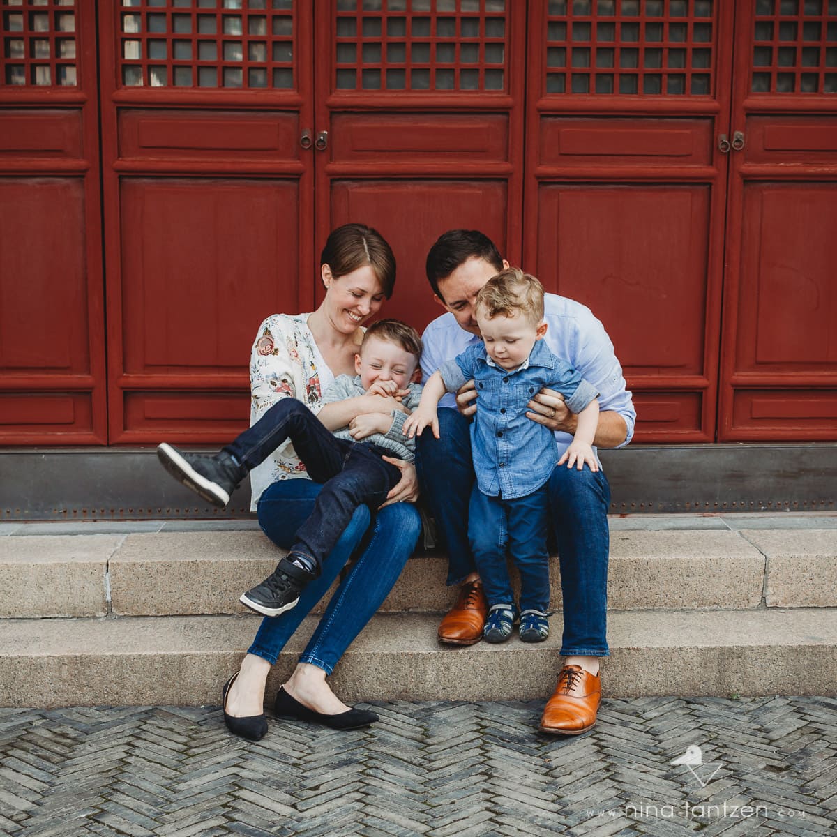 parents tickling their sons in a shanghai temple