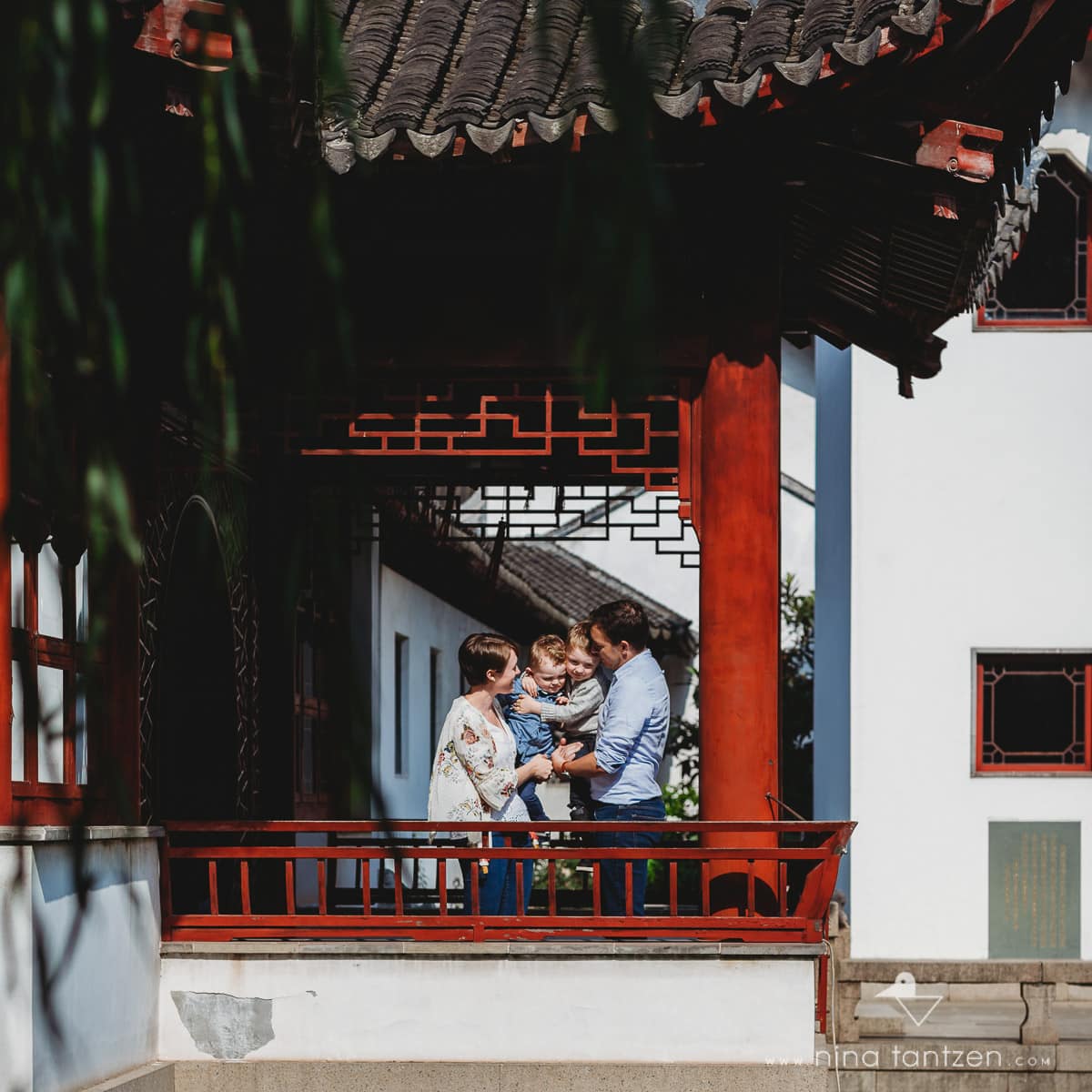 a family with 2 little boys in a chinese temple