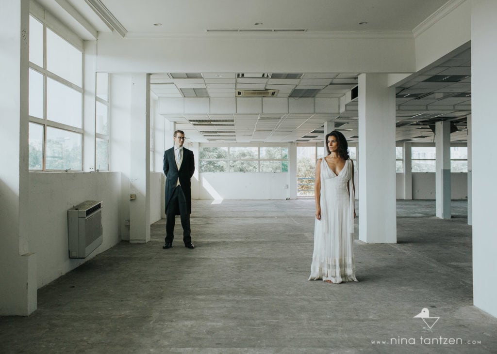 couple in wedding outfit in industrial hall