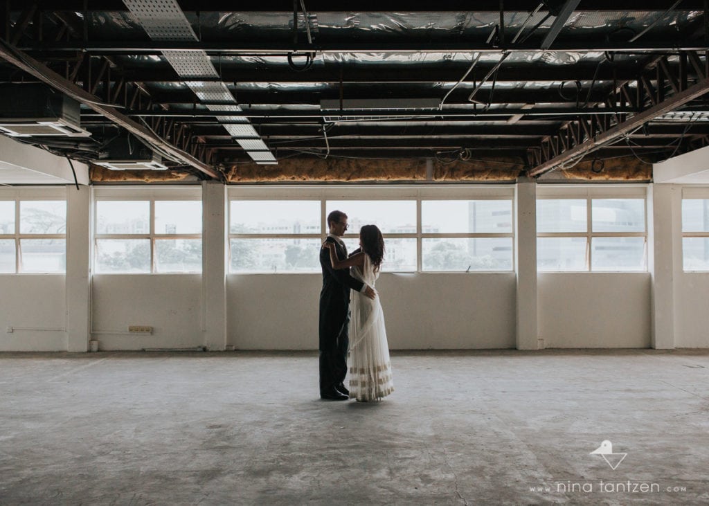 couple dancing in empty industrial building